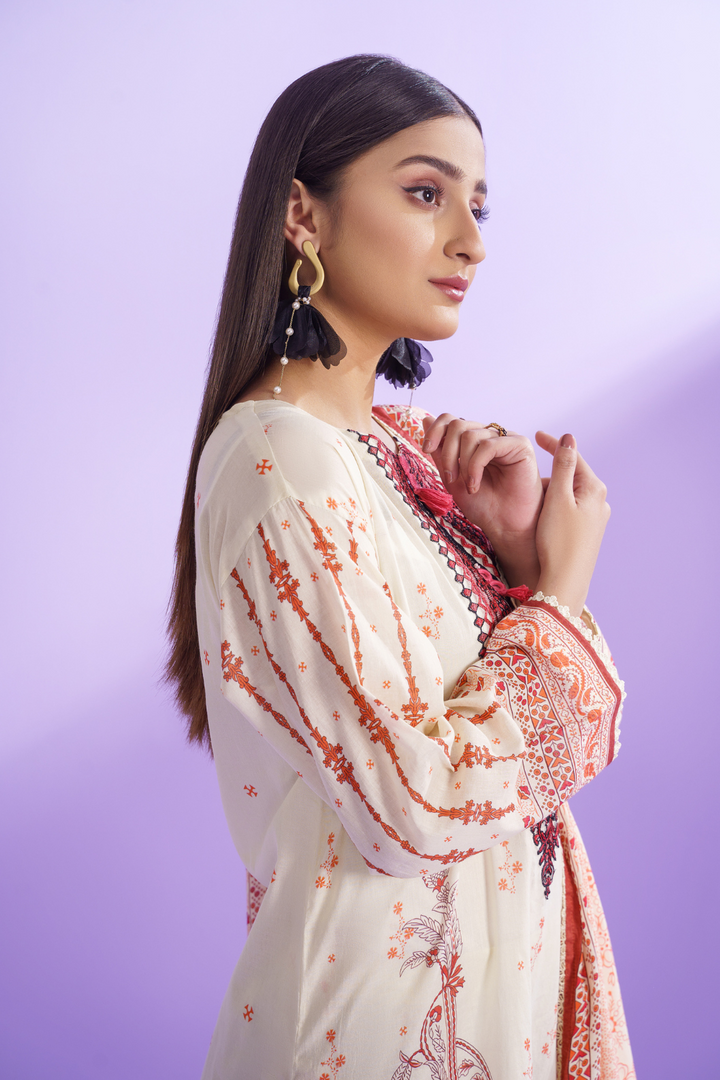 a woman wearing an Ittehad embroidered lawn dress.