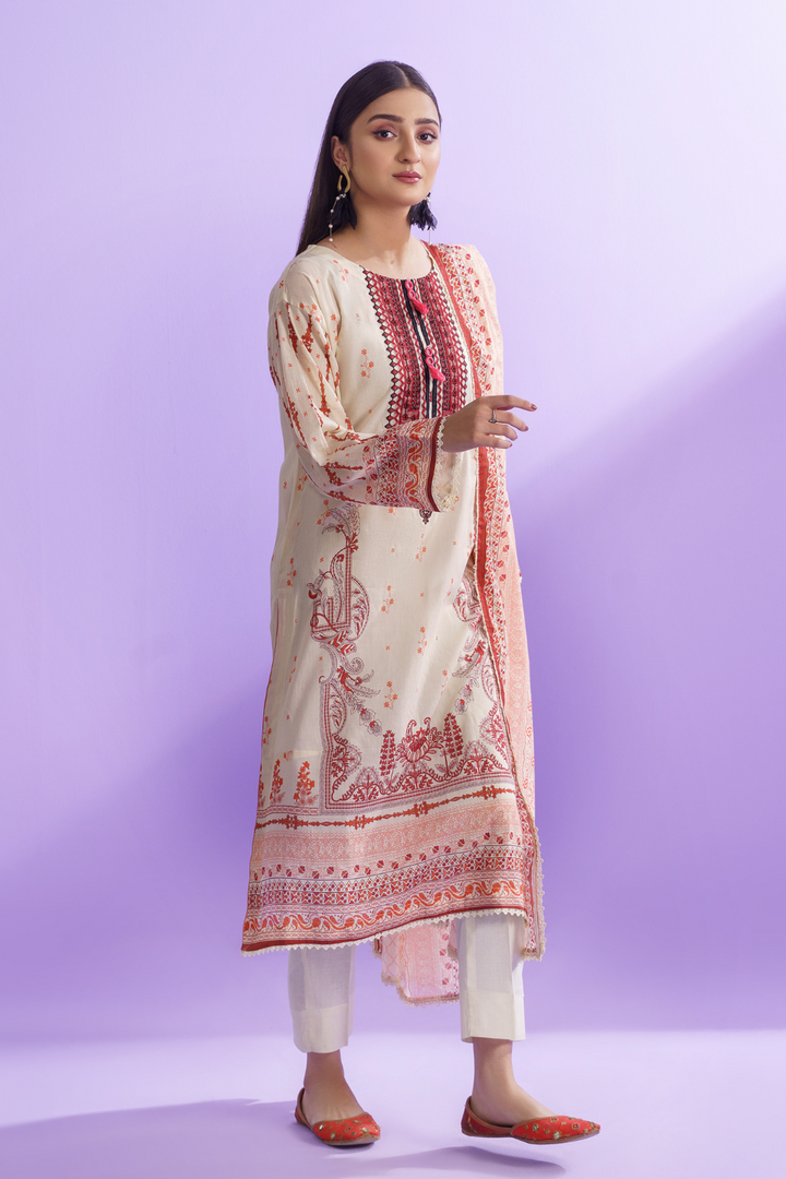 a woman wearing a beige and pink printed kurti suit.